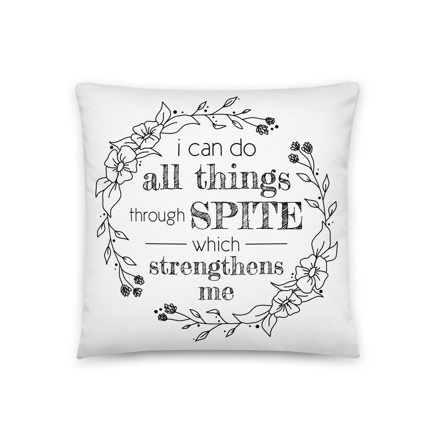 A white throw pillow decorated with an illustration of a floral wreath. Inside the flowers is text that reads "i can do all things through SPITE which strengthens me."