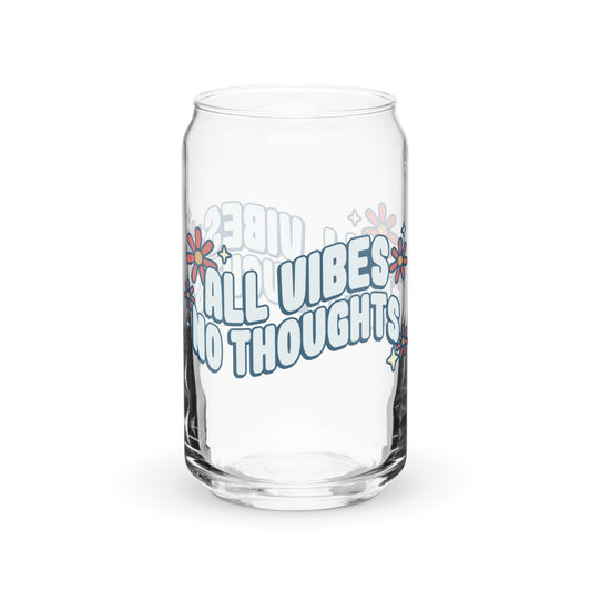 A can-shaped glass featuring text that reads "All vibes no thoughts". Around the text are pink flowers and pale yellow sparkles.