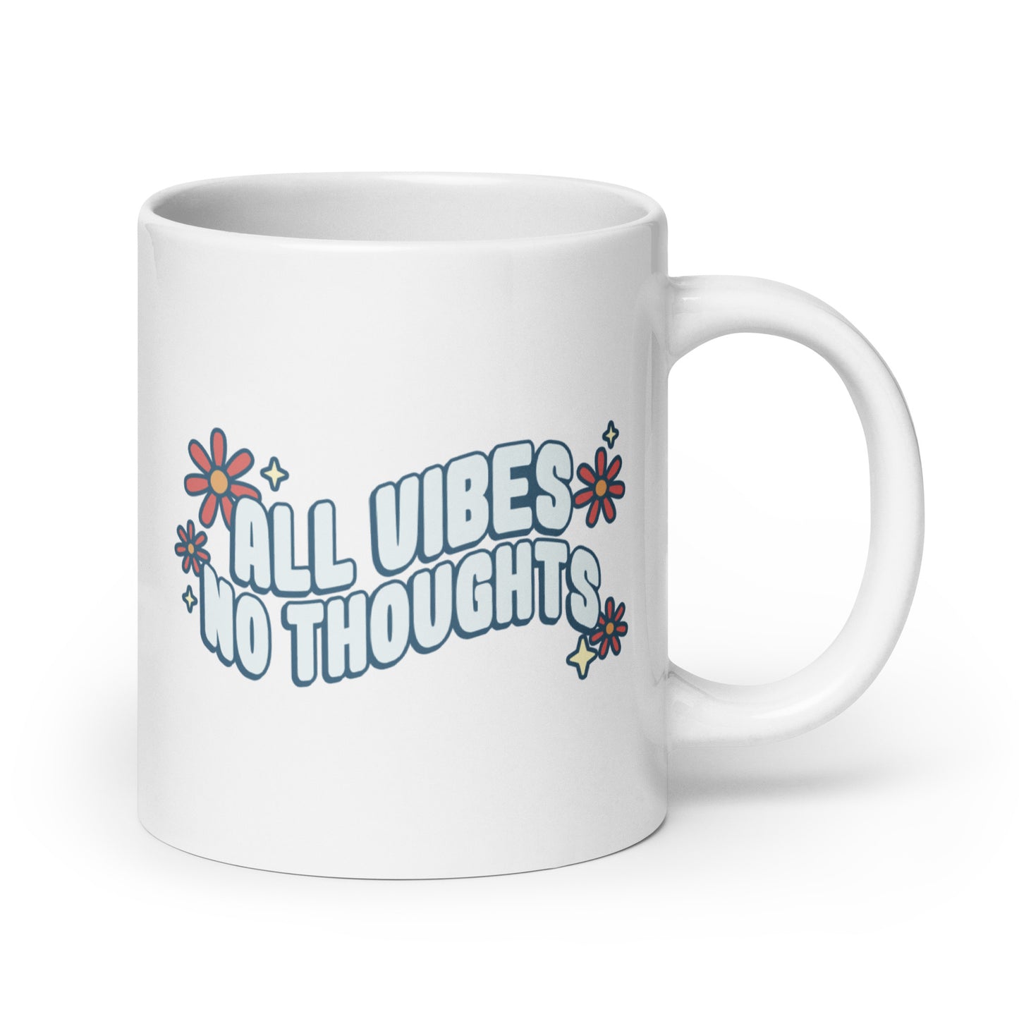 A white ceramic coffee mug featuring text that reads "All vibes no thoughts". Around the text are pink flowers and pale yellow sparkles.