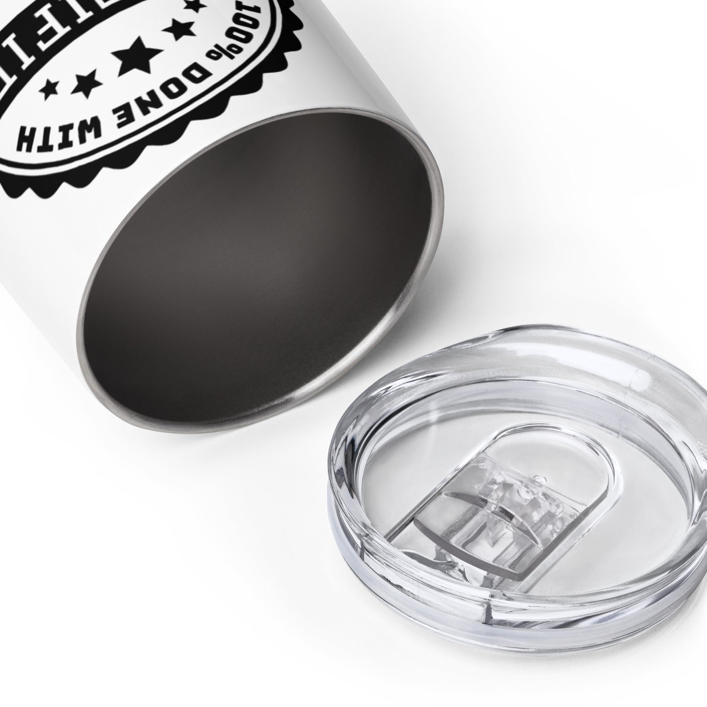 An open wine tumbler laying on its side. The stainless steel interior of the tumbler is visible. The tumbler's clear plastic lid is lying nearby.