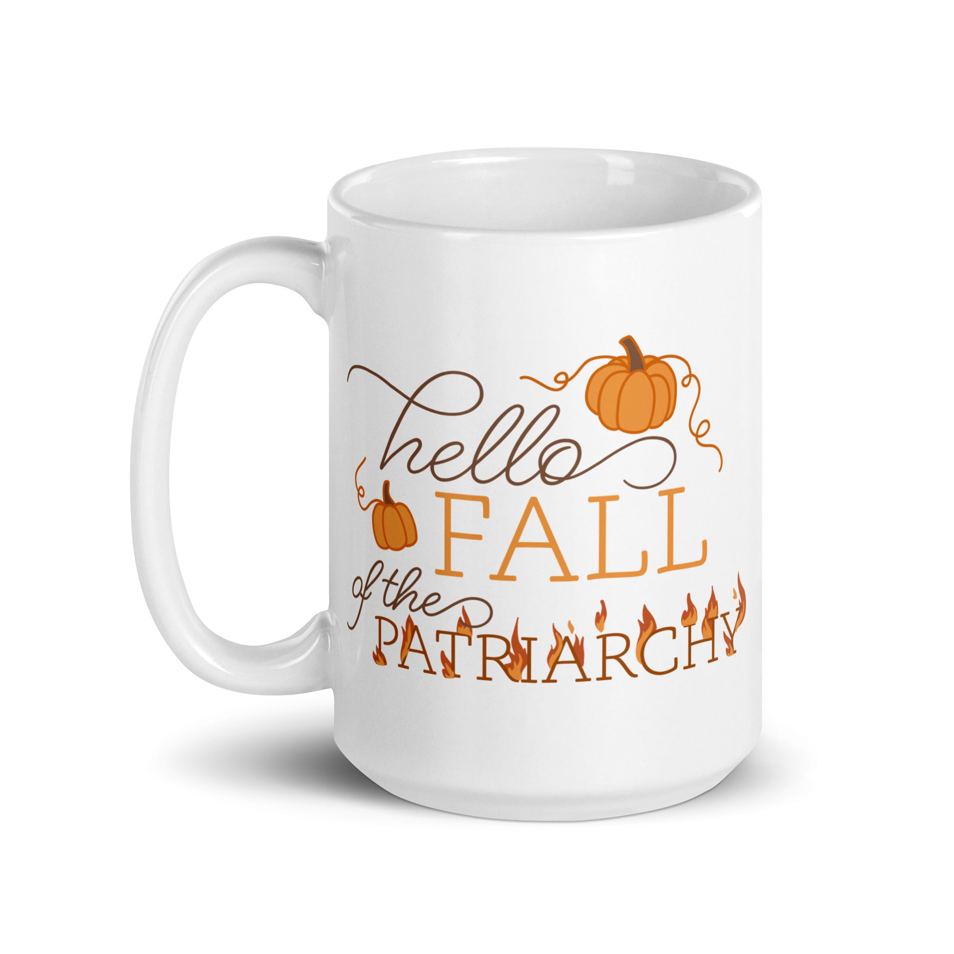 A white ceramic coffee mug featuring text in a blend of cursive and serif fonts that read "hello FALL of the PATRIARCHY". Pumpkins surround the upper half of the text, and the word "Patriarchy" is surrounded by flames.