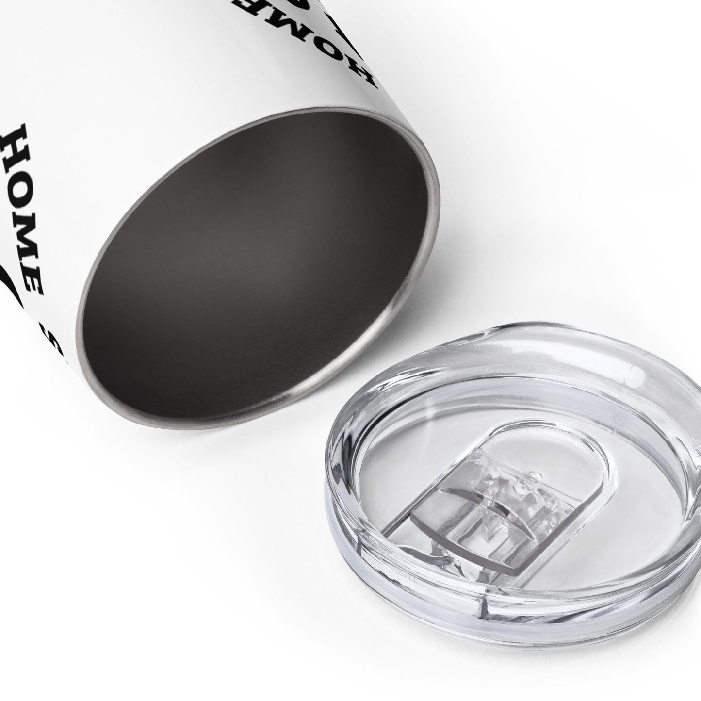 A white metal wine tumbler laying on its side, with the opening facing the viewer. The clear plastic lid is laying nearby.