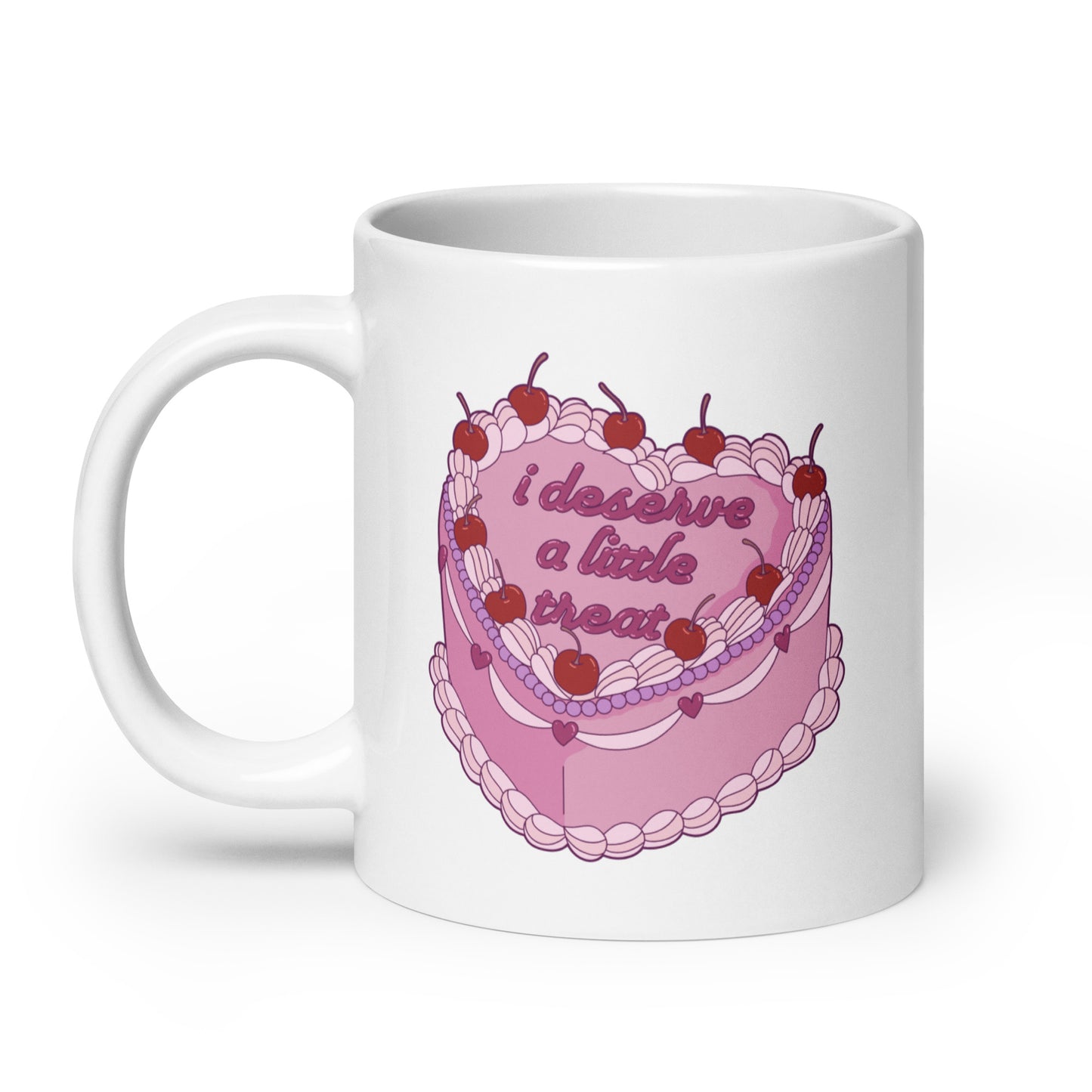 A 20 ounce, white ceramic mug featuring an illustration of an elaborately decorated pink cake. Icing on the cake reads "i deserve a little treat" in a cursive font.