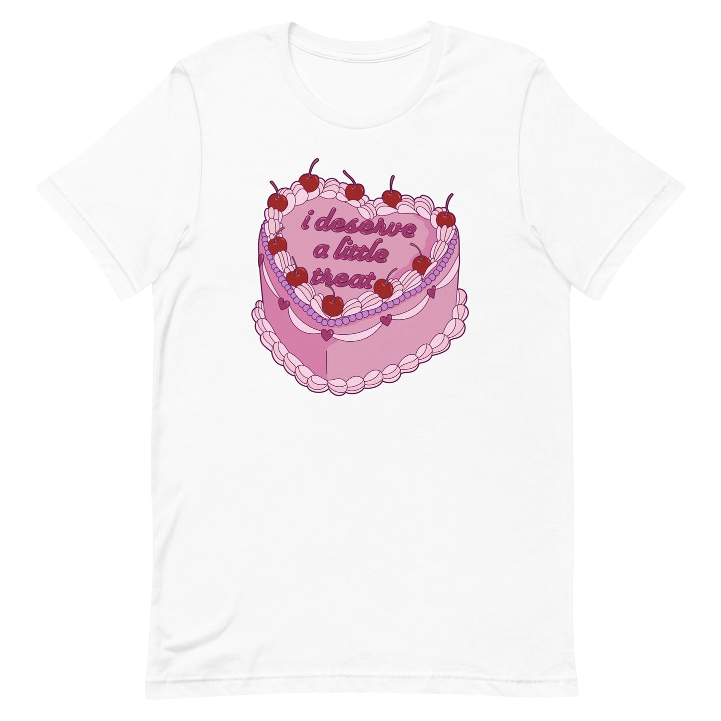 A white crewneck t-shirt featuring an illustration of an elaborately decorated pink cake. Icing on the cake reads "i deserve a little treat" in a cursive font.