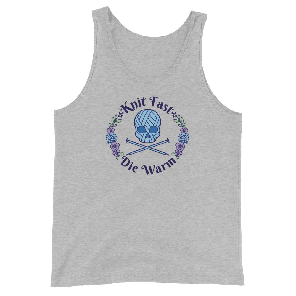 A grey tank top featuring an image of a skull and crossbones made of yarn and knitting needles. A floral wreath surrounds the skull, along with words that read "Knit Fast, Die Warm"