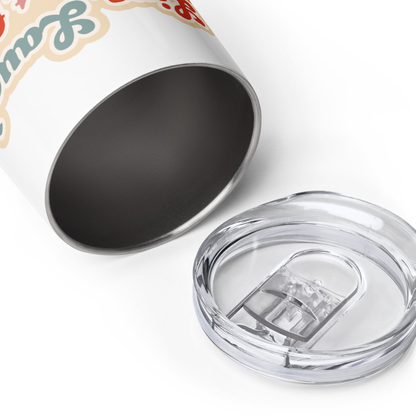A white wine tumbler laying on its side, showing the interior of the tumbler. The plastic lid is laying next to the open tumbler.