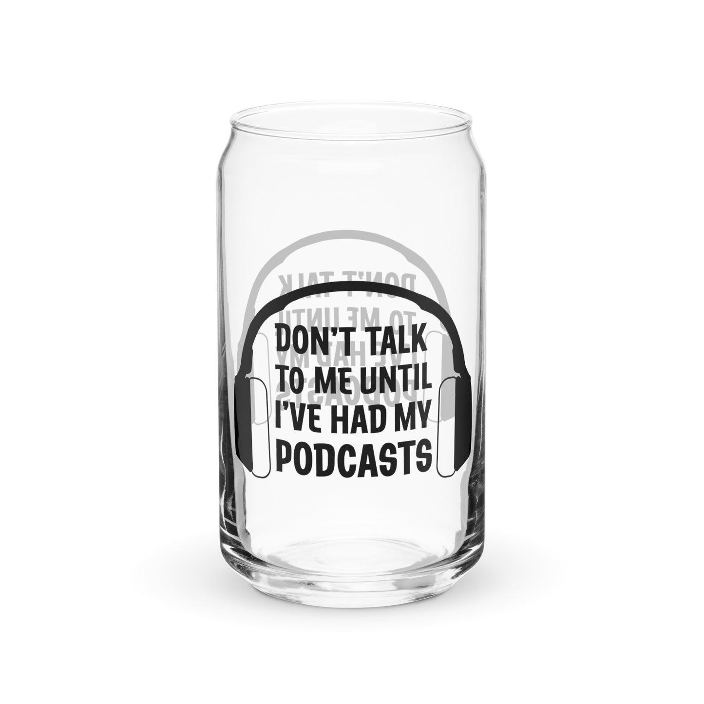 A front view of a can-shaped glass. The glass features an illustration of headphones surrounding text that reads "Don't talk to me until I've had my podcasts"