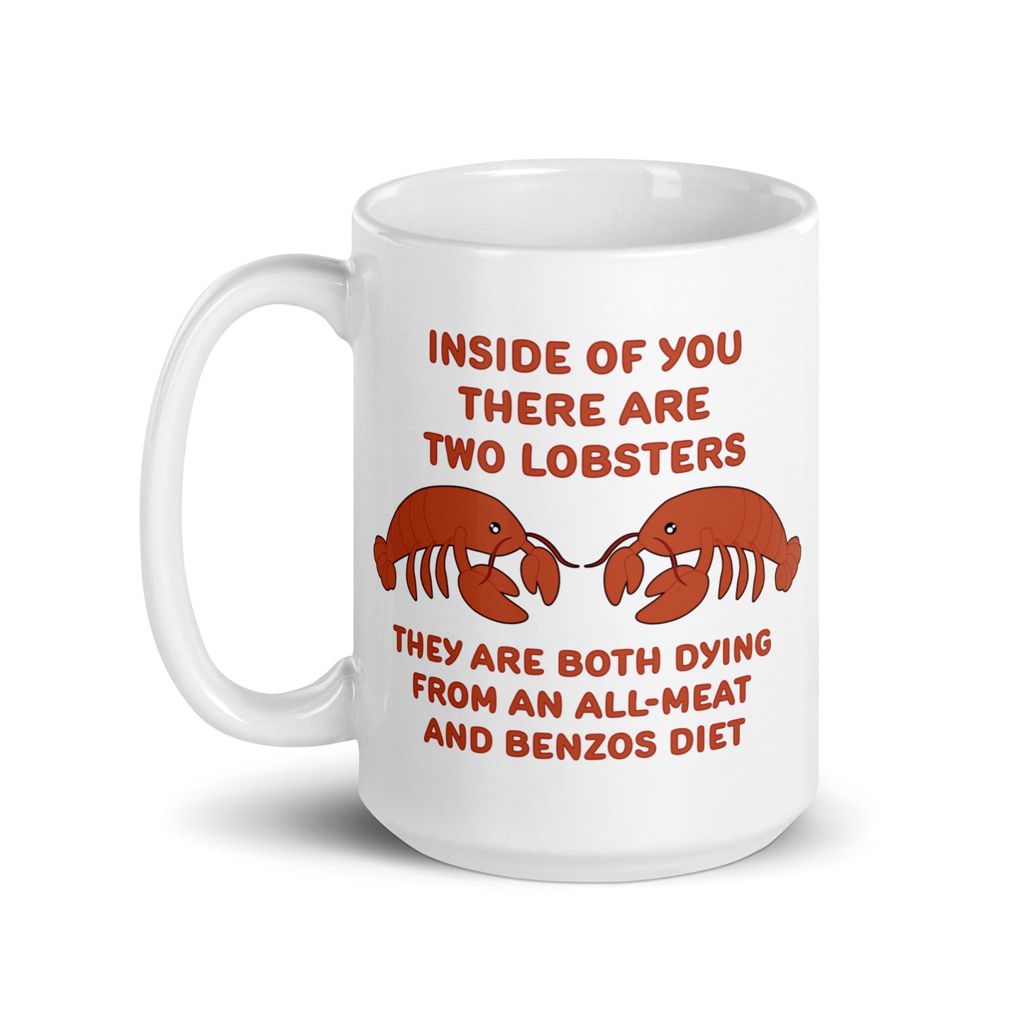 A white 15 ounce ceramic mug featuring an illustration of two lobsters. Text around the lobsters reads "Inside of you there are two lobsters." "They are both dying from an all-meat and benzos diet."