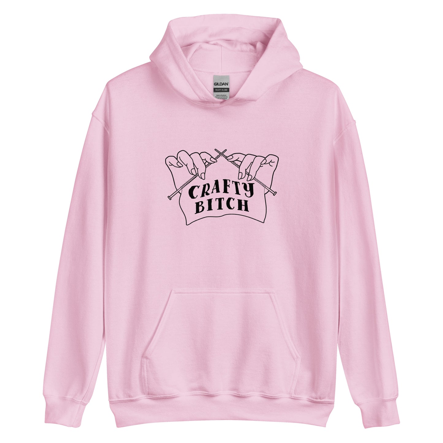 A light pink hooded sweatshirt featuring a single-color illustration of a pair of hands holding knitting needles. Fabric on the needles features text that reads "crafty bitch".