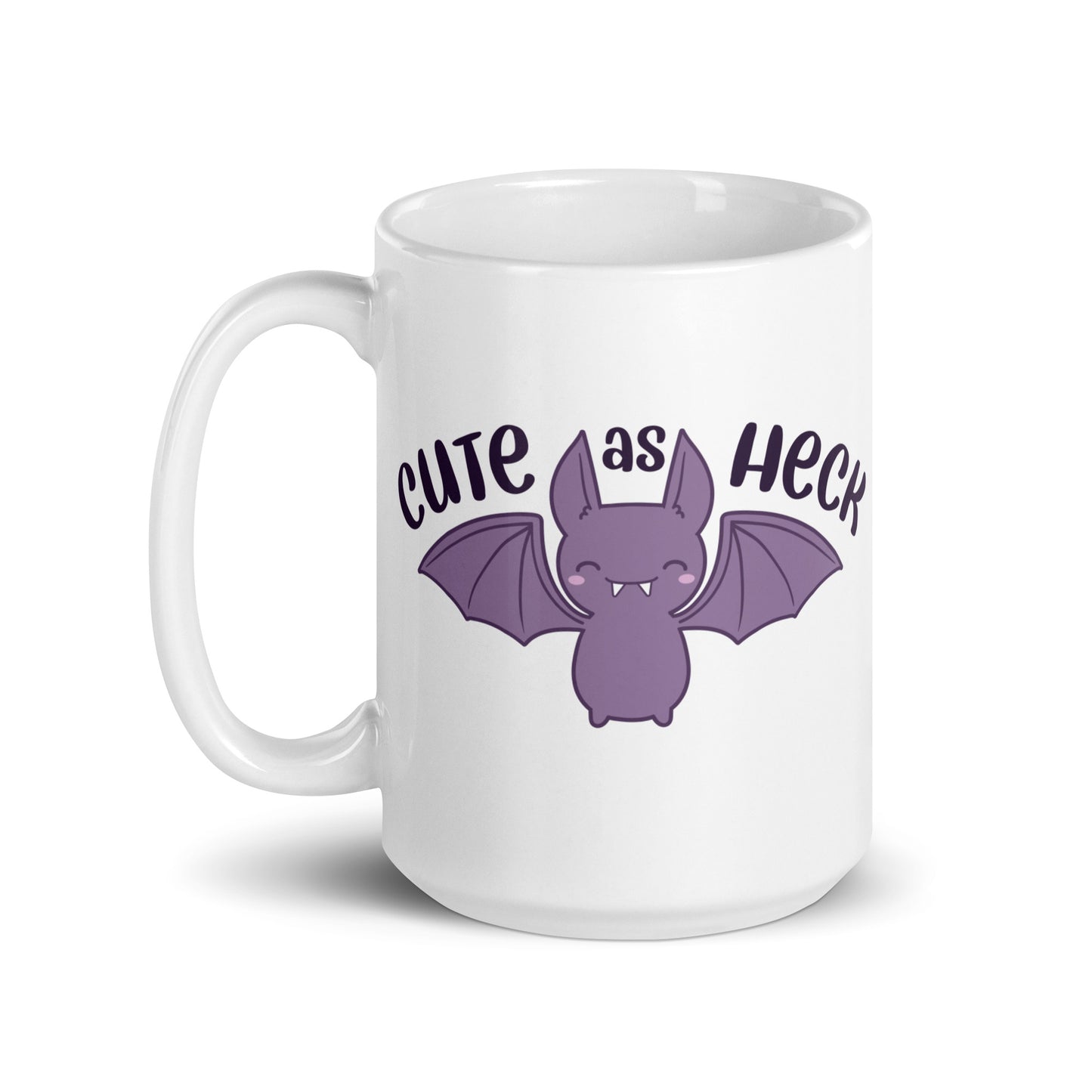A 15 ounce white ceramic mug featuring an illustration of a smiling purple bat. Above the bat is text that reads "Cute As Heck"