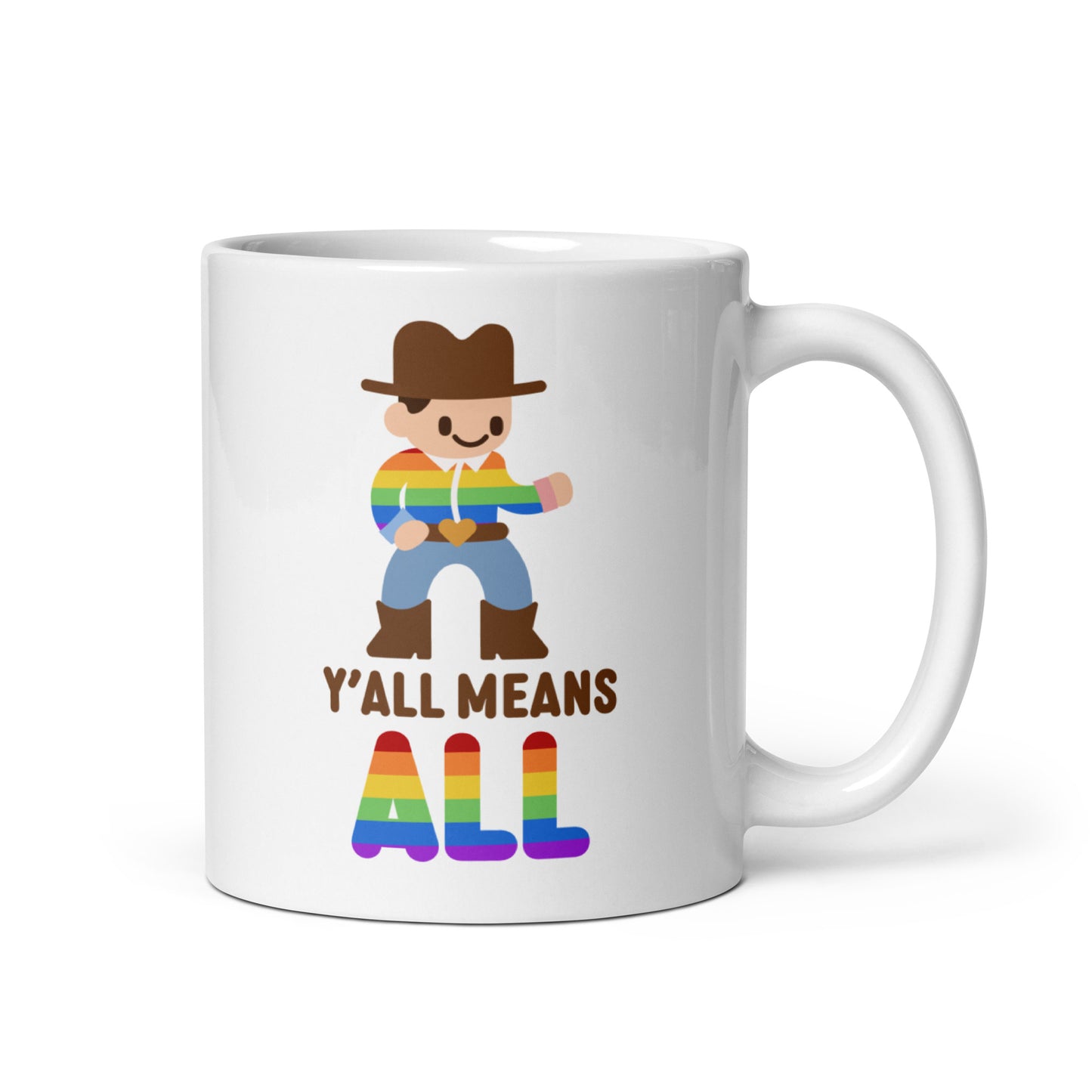 A white 11 ounce coffee mug featuring an illustration of a smiling cowboy wearing a rainbow striped shirt. Text underneath the cowboy reads "Y'all means ALL". The word "ALL" is rainbow-colored to match the cowboy's shirt.