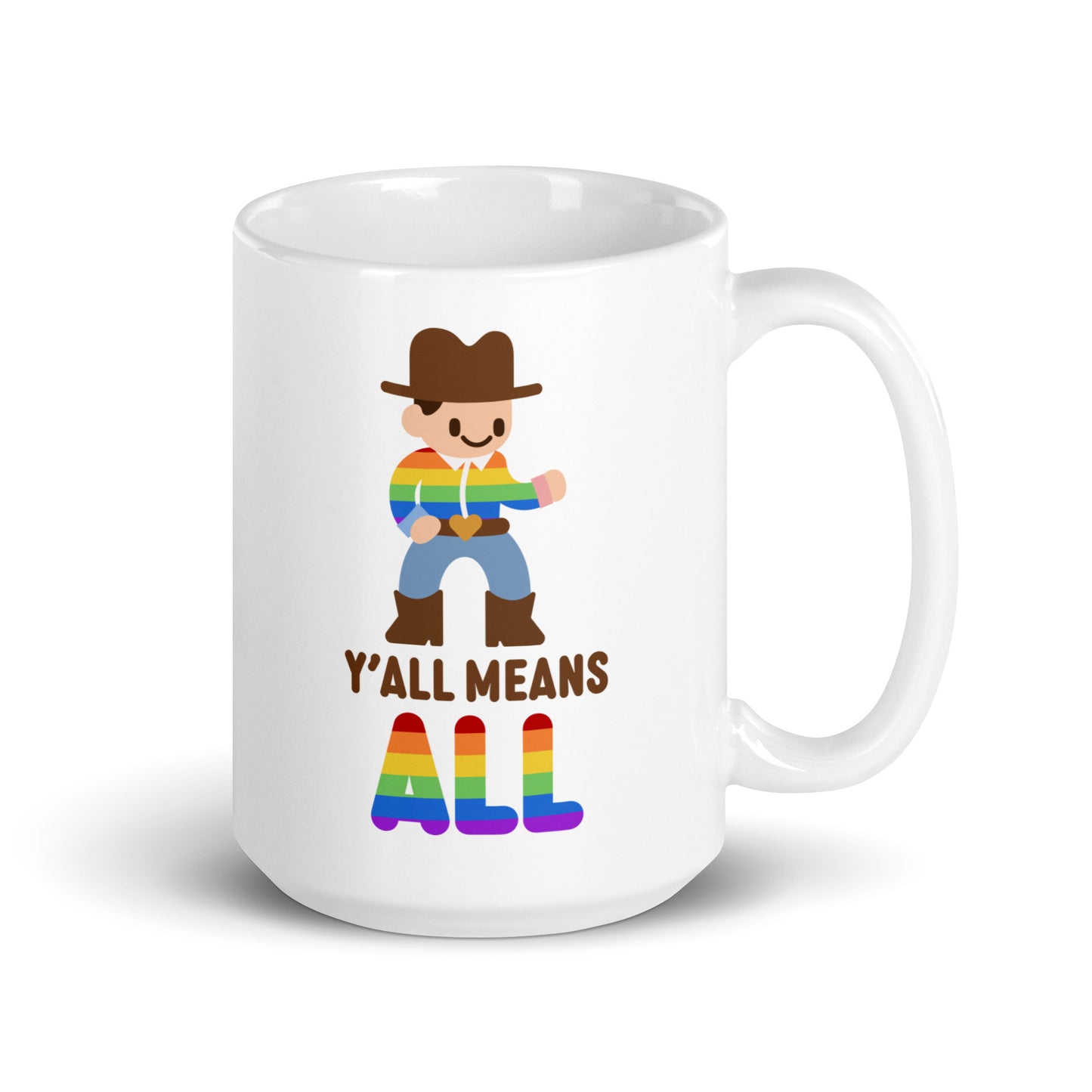 A white 15 ounce coffee mug featuring an illustration of a smiling cowboy wearing a rainbow striped shirt. Text underneath the cowboy reads "Y'all means ALL". The word "ALL" is rainbow-colored to match the cowboy's shirt.