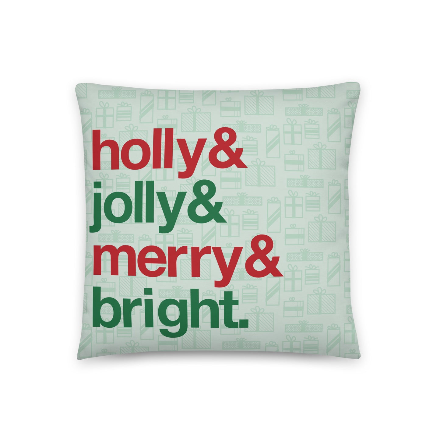 An 18" by 18" throw pillow decorated with a pale green background pattern of presents. There are also four lines of red and green text on the pillow that read "Holly & jolly & merry & bright"
