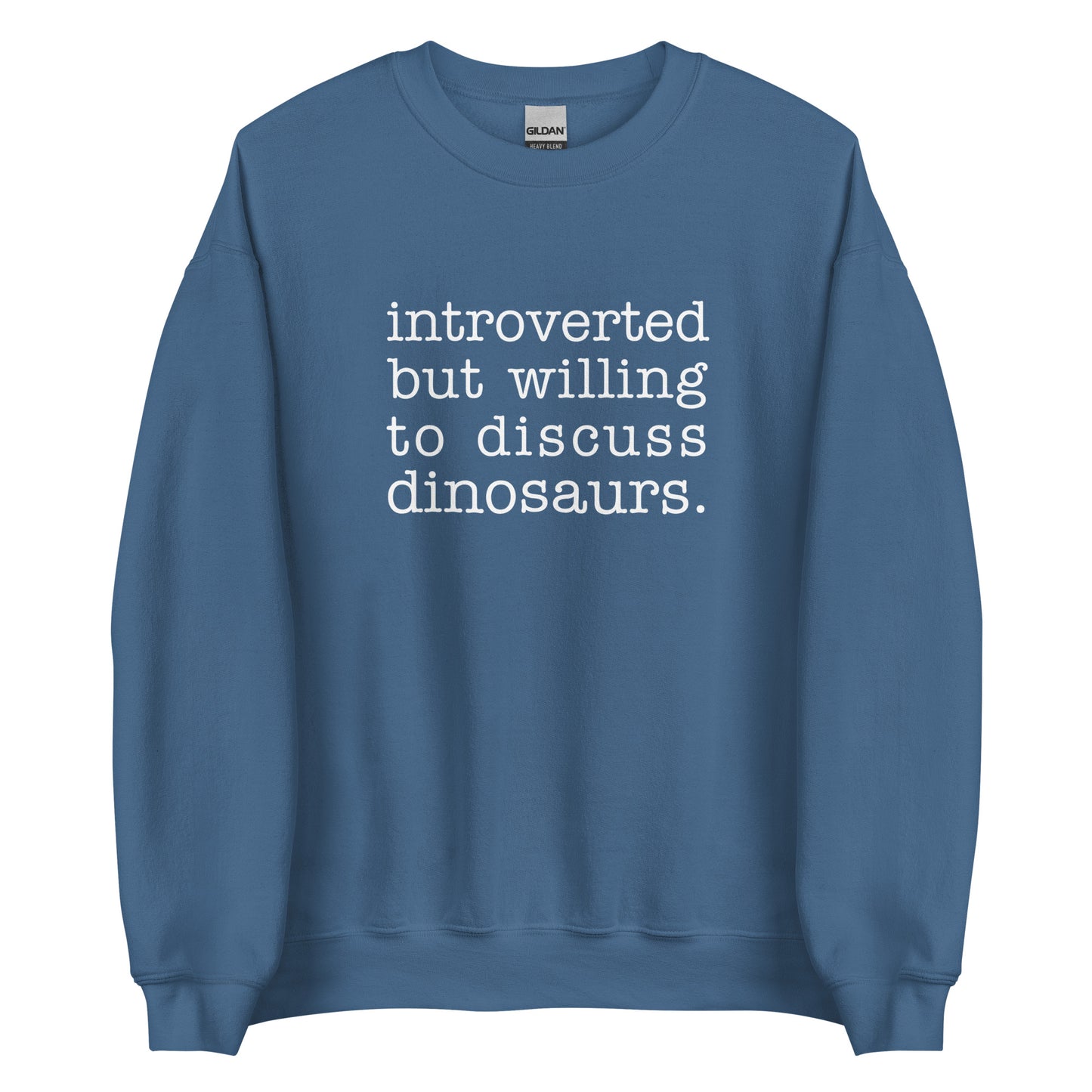 A blue crewneck sweatshirt with white text reading "introverted but willing to discuss dinosaurs"