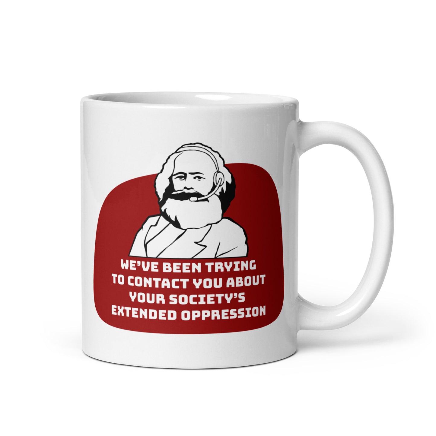 An 11 ounce, white ceramic mug featuring a black and white illustration of Karl Marx wearing a telemarketer headset. Text beneath Marx reads "We've been trying to contact you about your society's extended oppression." in a blocky font.