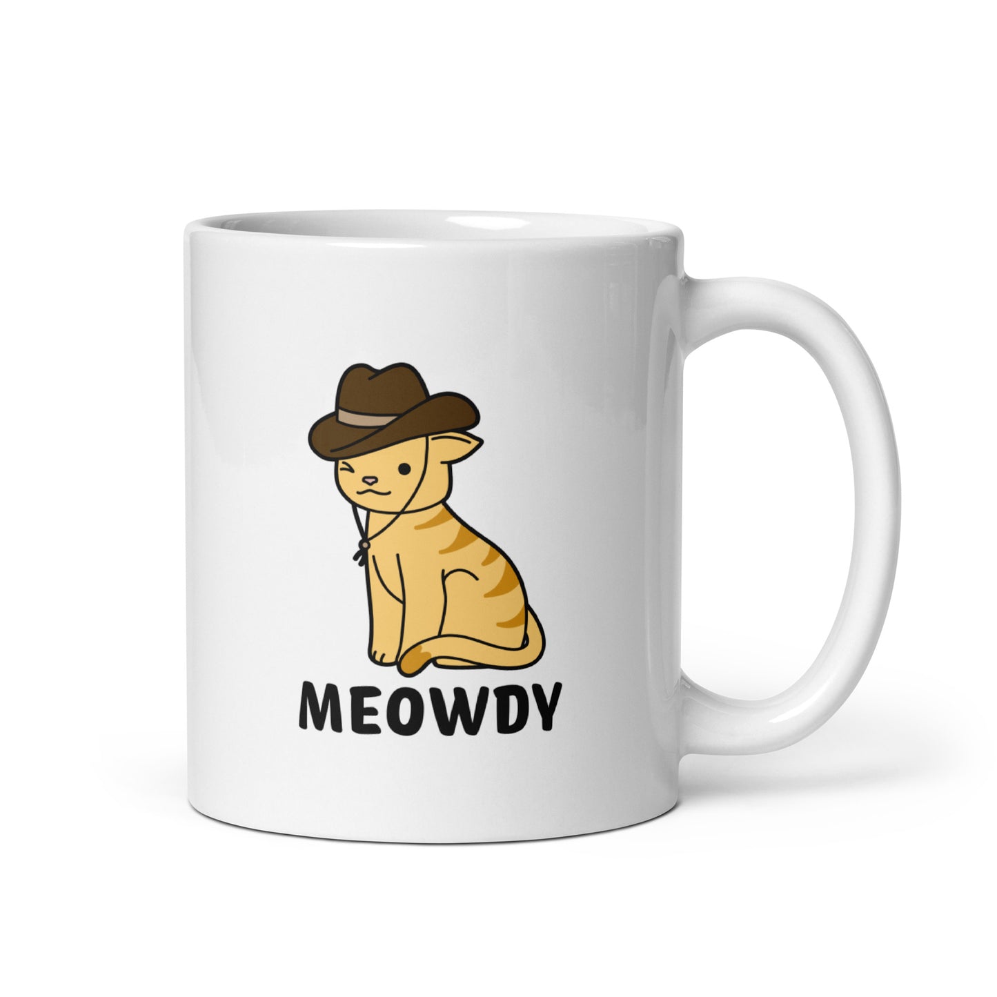A white, 11 ounce ceramic coffee mug featuring an illustration of an orange striped cat wearing a cowboy hat. The cat is winking and smiling, and text beneath him reads "Meowdy"