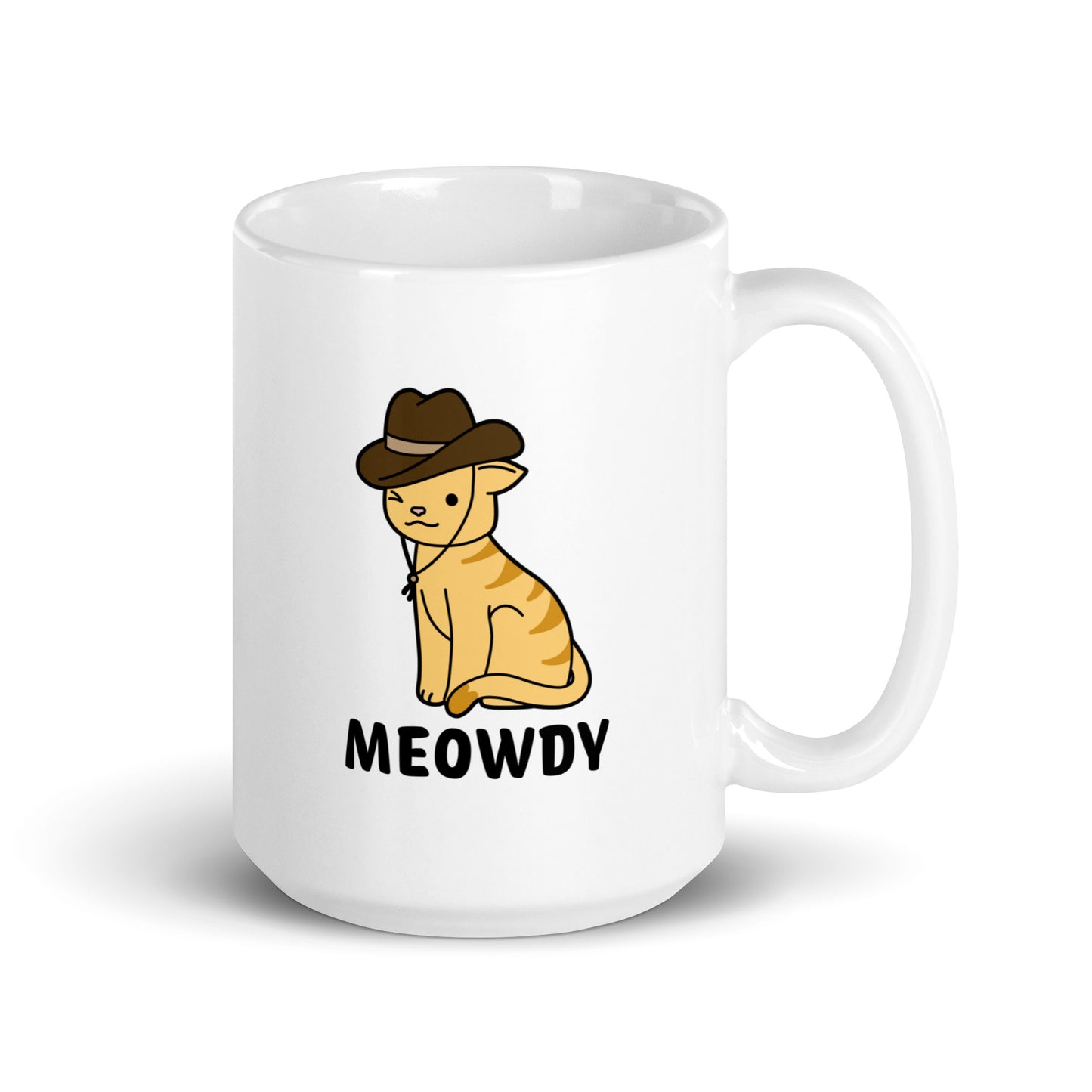 A white, 15 ounce ceramic coffee mug featuring an illustration of an orange striped cat wearing a cowboy hat. The cat is winking and smiling, and text beneath him reads "Meowdy"
