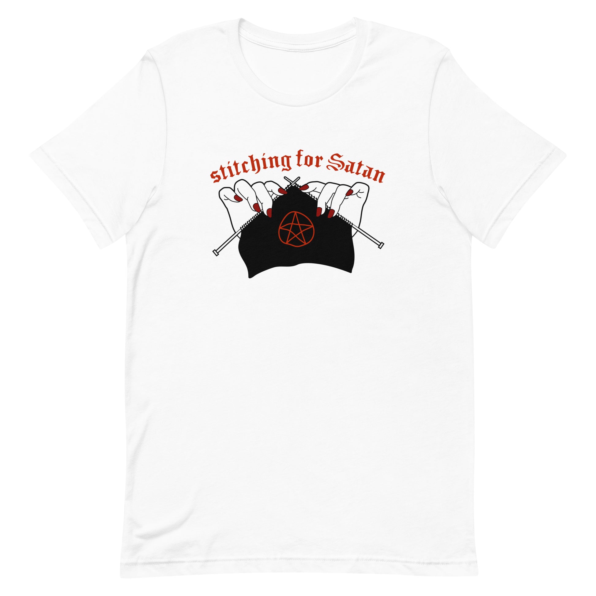 A white crewneck t-shirt featuring an illustration of pale white hands with red fingernails holding knitting needles. Fabric on the needles features a red pentagram. Text above the hands reads "stitching for Satan" in a gothc red font.
