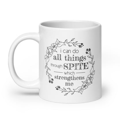 A white ceramic mug featuring a simple illustration of a floral wreath. Inside the wreath is text that reads "I can do all things through SPITE which motivates me"