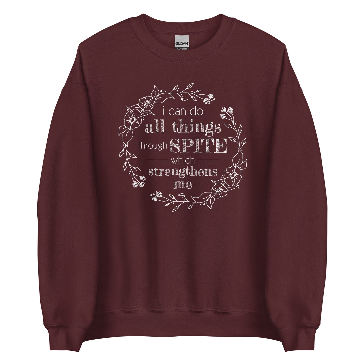 A maroon crewneck sweatshirt featuring an illustration of a floral wreath. Text inside the flowers reads "i can do all things through SPITE which strengthens me"