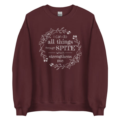 A maroon crewneck sweatshirt featuring an illustration of a floral wreath. Text inside the flowers reads "i can do all things through SPITE which strengthens me"