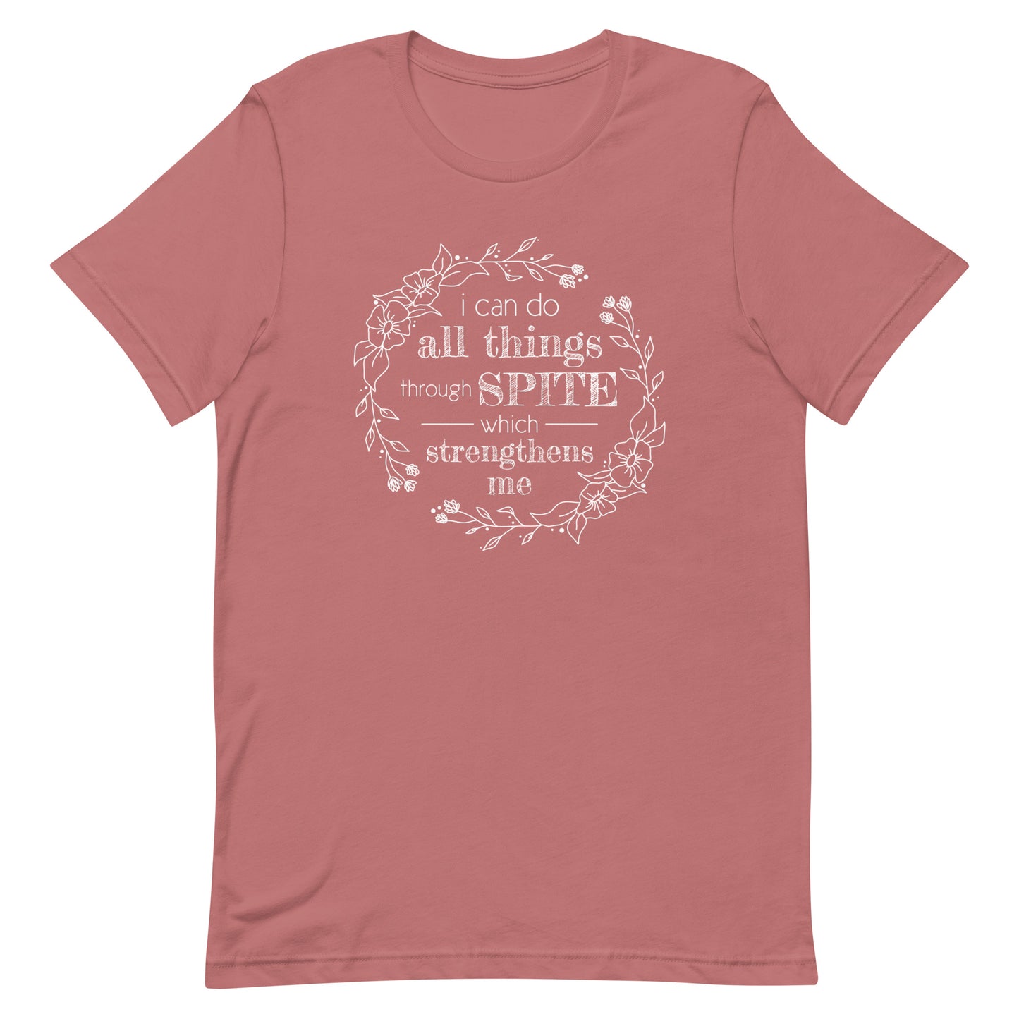 A dusky pink crewneck t-shirt with an illustration of a wreath of flowers. Inside the wreath is text that reads "I can do all things through spite which strengthens me"