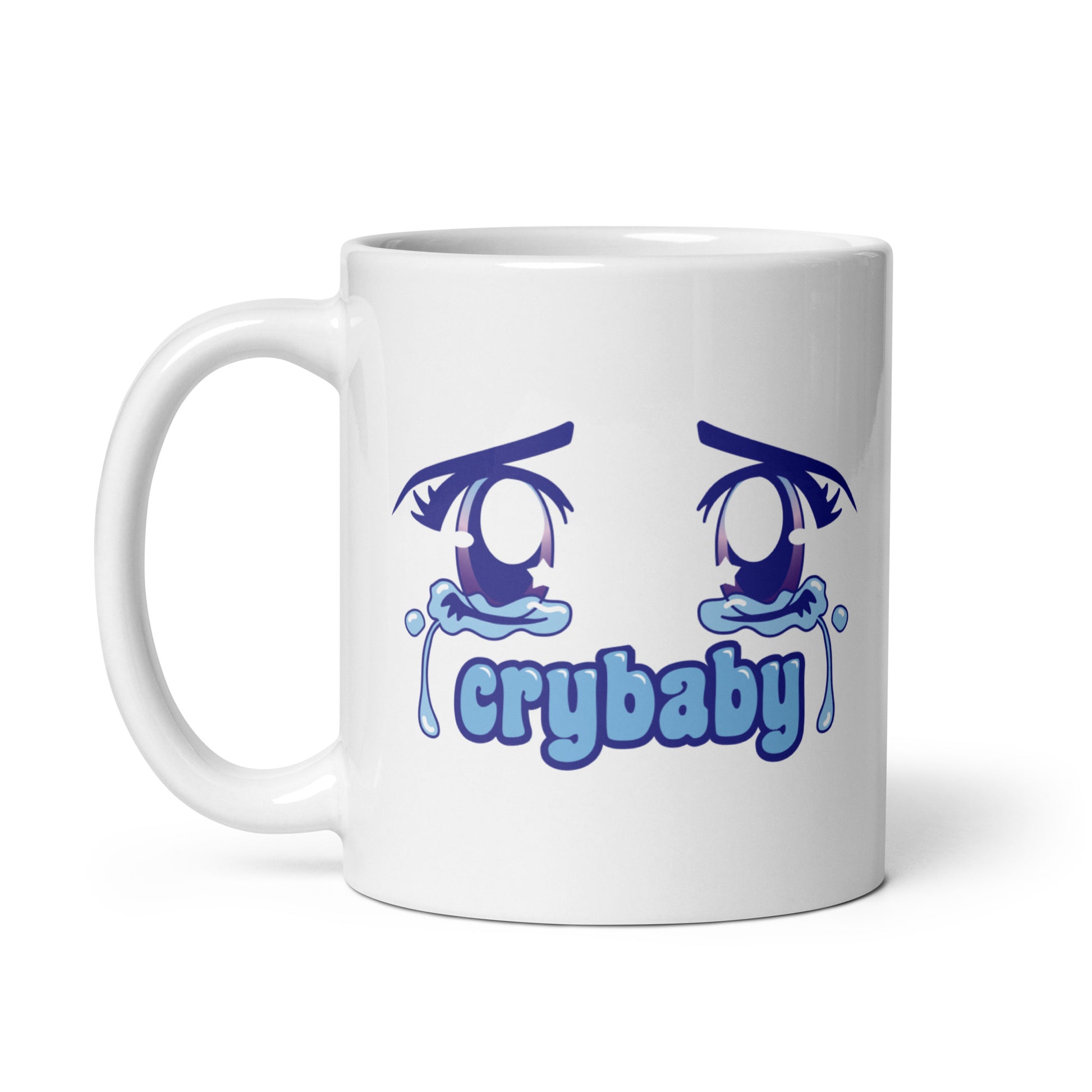 A white 11 ounce coffee mug featuring large, sparkling purple anime eyes with tears streaming down. Text underneath the eyes in a rounded blue font reads "crybaby"