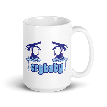 A white 15 ounce coffee mug featuring large, sparkling purple anime eyes with tears streaming down. Text underneath the eyes in a rounded blue font reads "crybaby"