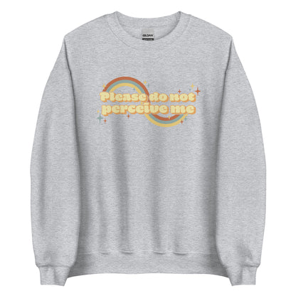 A light grey crewneck sweatshirt featuring vintage-style text that reads "Please do not perceive me". A colorful swirl and sparkles surrounds the text in red, yellow, and blue.