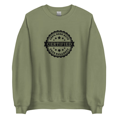 An olive green crewneck sweatshirt featuring a graphic of an official-looking stamped seal. Text on the seal reads: "CERTIFIED: 100% done with this bullshit"