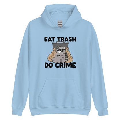 A light blue hooded sweatshirt featuring an illustration of a chubby raccoon wearing sunglasses. The raccoon is leaning back against a trash can and two large bags of money. Text surrounding the image reads "Eat Trash. Do Crime."
