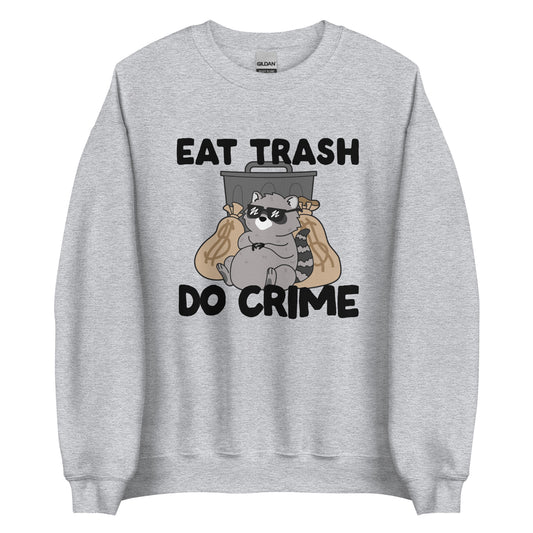 A crewneck sweatshirt featuring an illustration of a chubby raccoon wearing sunglasses. The raccoon is leaning back against a trashcan and two large bags of money. Text surrouding the image reads "Eat Trash. Do Crime."