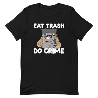 A black crewneck t-shirt featuing an illustration of a chubby raccoon wearing sunglasses. The raccoon is laying back against a trash can and large bags of money. Text surrounding the image reads "Eat trash. Do crime."