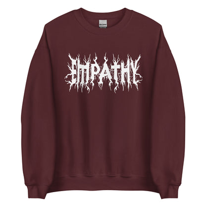 A maroon crewneck sweatshirt featuring white text that reads "Empathy" in a jagged font in the style of heavy metal band shirts