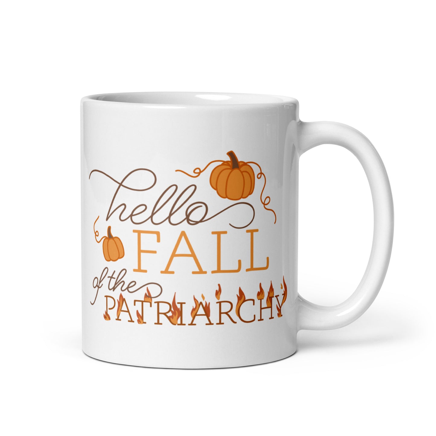 A white ceramic coffee mug featuring text in a blend of cursive and serif fonts that read "hello FALL of the PATRIARCHY". Pumpkins surround the upper half of the text, and the word "Patriarchy" is surrounded by flames.