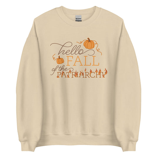 A cream-colored crewneck sweatshirt featuring text that reads "Hello fall of the patriarchy". Pumpkins surround the first half of the text and the word "patriarchy" is on fire.