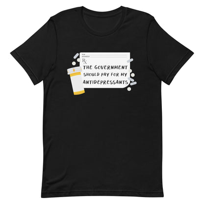 A black crewneck t-shirt featuring an image of a subscription page with text that reads "The government should pay for my antidepressants". Pills and an empty orange pill bottle surround the RX sheet.