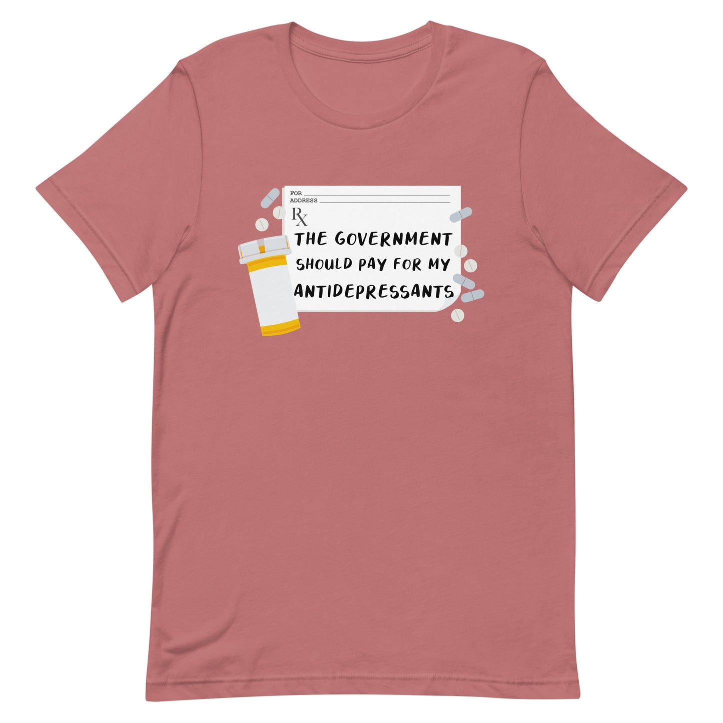 A dusky pink crewneck t-shirt featuring an image of a subscription page with text that reads "The government should pay for my antidepressants". Pills and an empty orange pill bottle surround the RX sheet.
