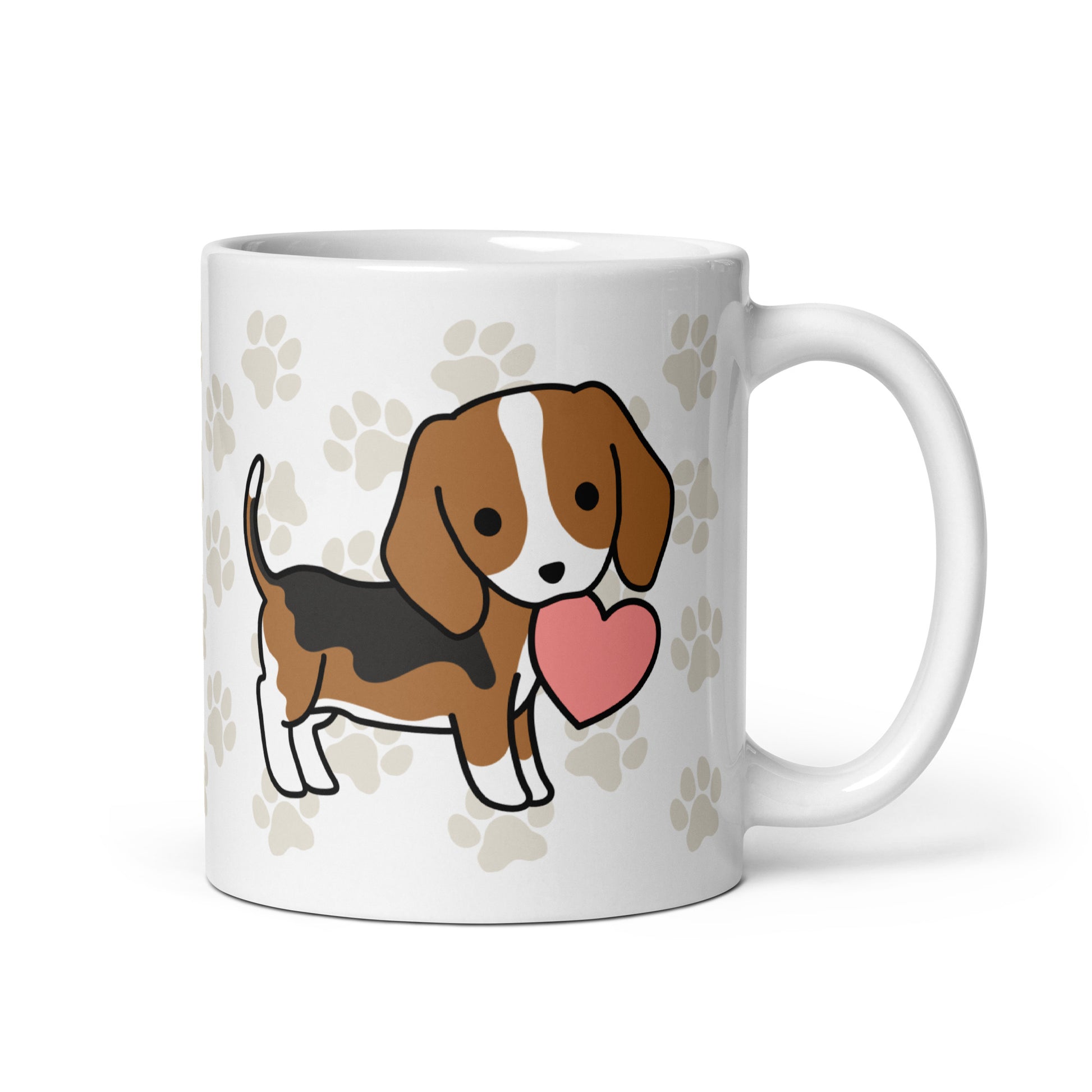 A white 11 ounce ceramic mug with a pattern of light brown pawprints all over. The mug also features a stylized illustration of a Beagle holding a heart in its mouth.