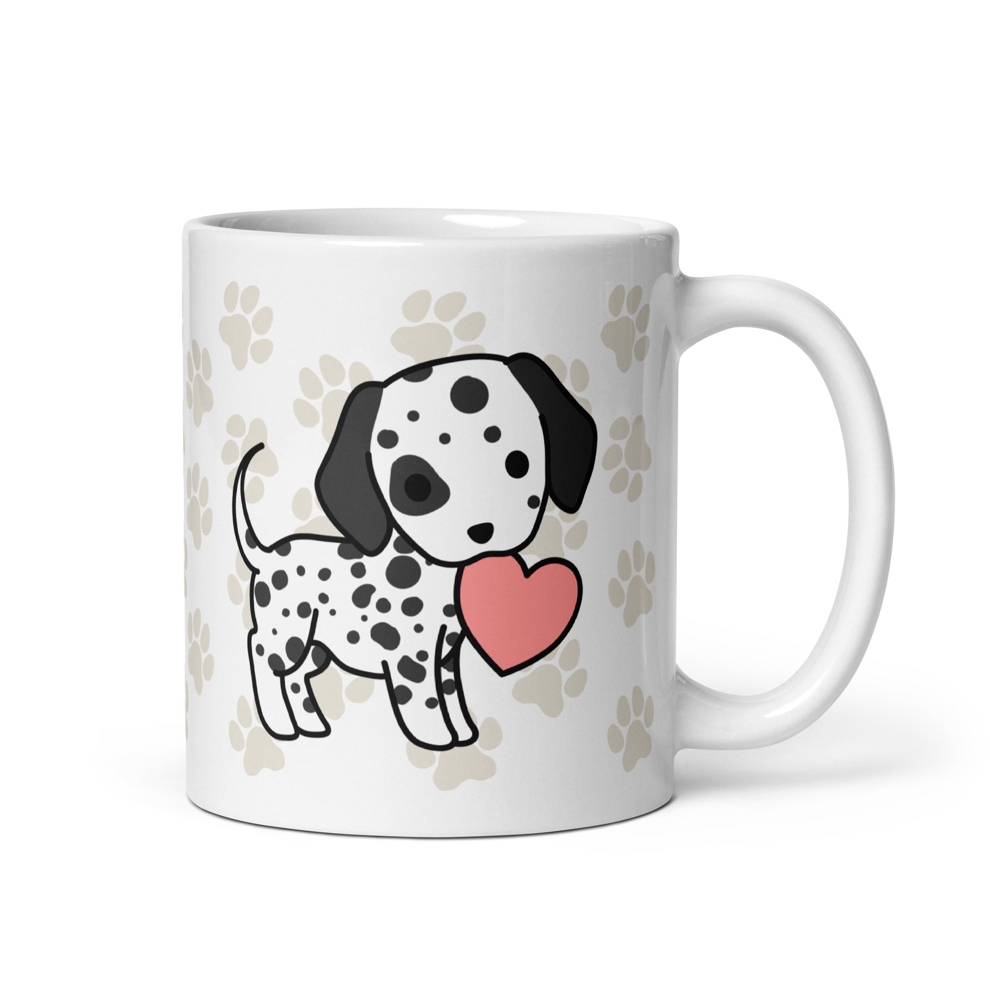 A white 11 ounce ceramic mug with a pattern of light brown pawprints all over. The mug also features a stylized illustration of a Dalmatian holding a heart in its mouth.
