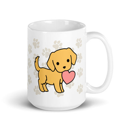 A white 15 ounce ceramic mug with a pattern of light brown pawprints all over. The mug also features a stylized illustration of a Golden Retriever holding a heart in its mouth.