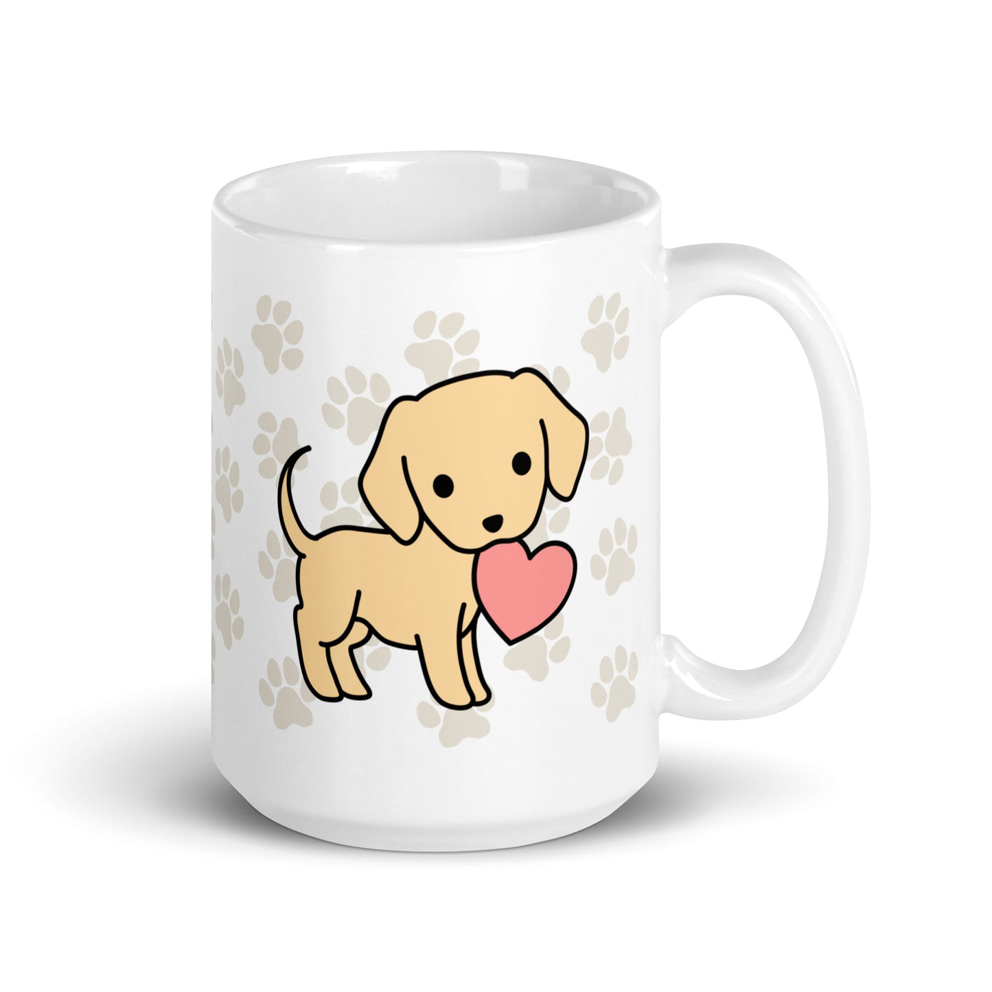 A white 15 ounce ceramic mug with a pattern of light brown pawprints all over. The mug also features a stylized illustration of a Yellow Lab holding a heart in its mouth.