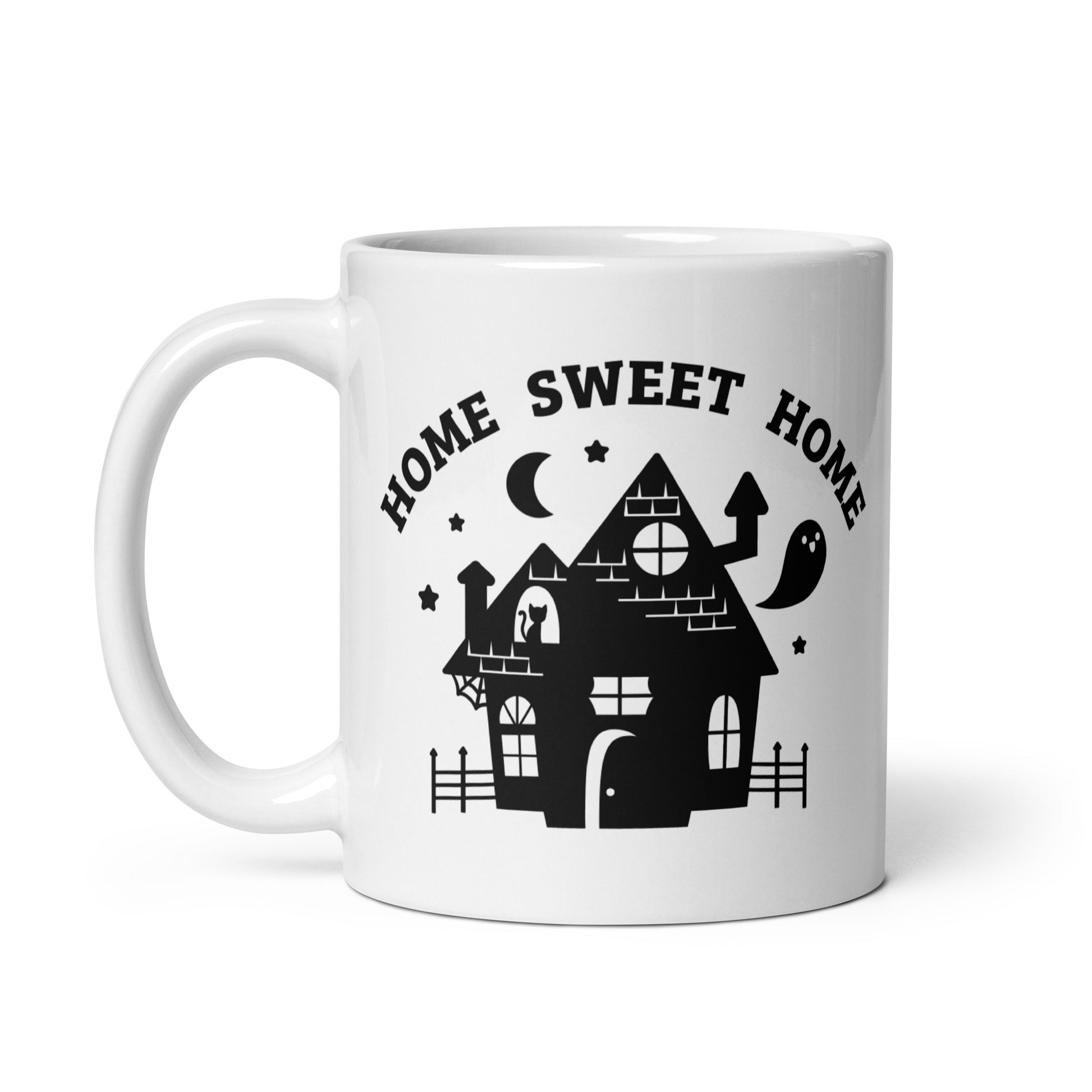 A white 11 ounce ceramic coffee mug featuring an illustration of a haunted house. Text above the house in an arc reads "Home Sweet Home"