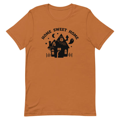 A burnt orange crewneck t-shirt featuring a single-color illustration of a haunted house. Text above the house reads "HOME SWEET HOME".