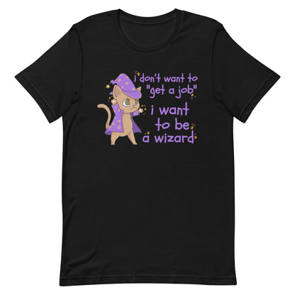 A black t-shirt featuring an illustration of a small brown cat wearing a wizard's hat and robes. Scribbly text next to the cat reads "i don't want to "get a job". i want to be a wizard".
