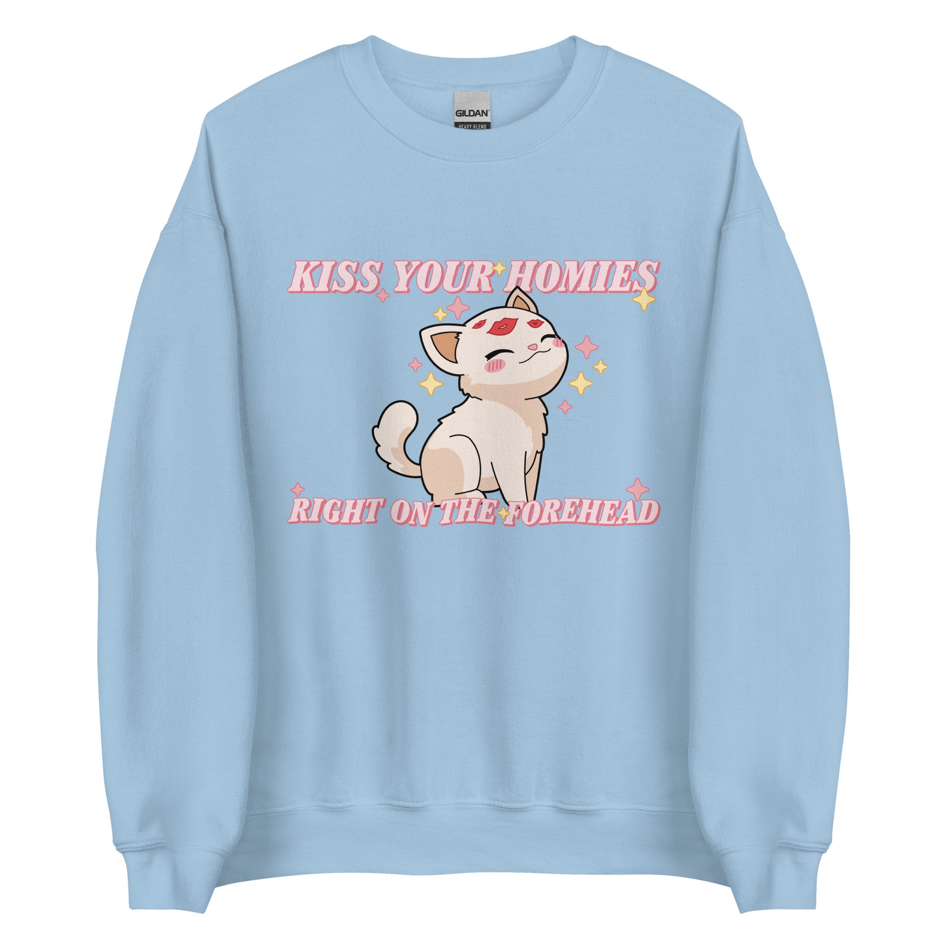 A light blue crewneck sweatshirt featuring an illustration of a soft white kitten. Lipstick kiss marks are on the kitten's forehead, and its face is surrounded by sparkles. Pink text around the kitten reads "Kiss your homies right on the forehead."