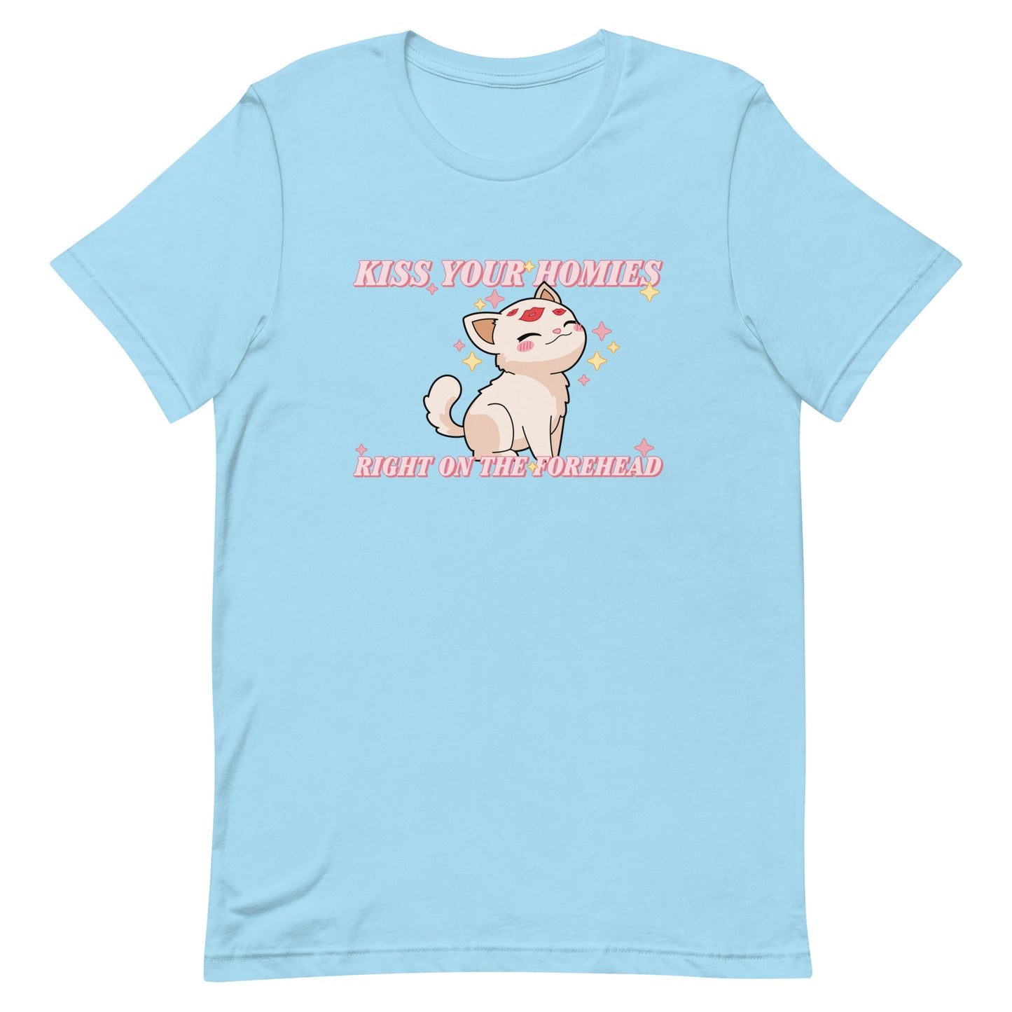 A light blue crewneck t-shirt featuring an illustration of a soft white kitten. Lipstick kiss marks are on the kitten's forehead, and its face is surrounded by sparkles. Pink text around the kitten reads "Kiss your homies right on the forehead."