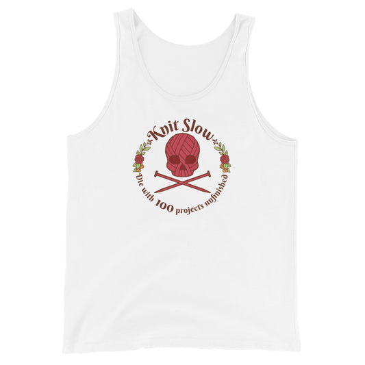 A white tank top featuring an image of a skull and crossbones made of yarn and knitting needles. A floral wreath surrounds the skull, along with words that read "Knit Slow, Die with 100 projects unfinished"