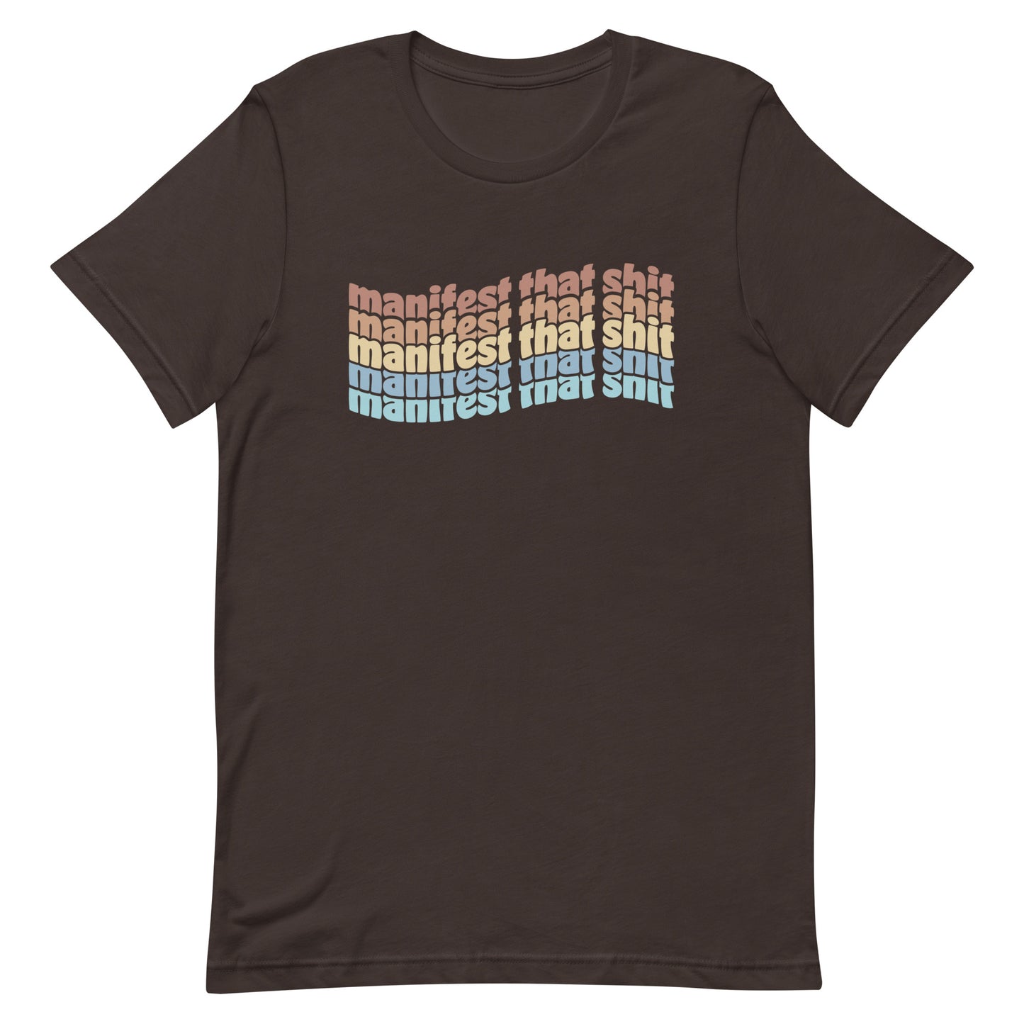 A brown crewneck t-shirt featuring stacked text that reads "manifest that shit" in a rainbow of colors.