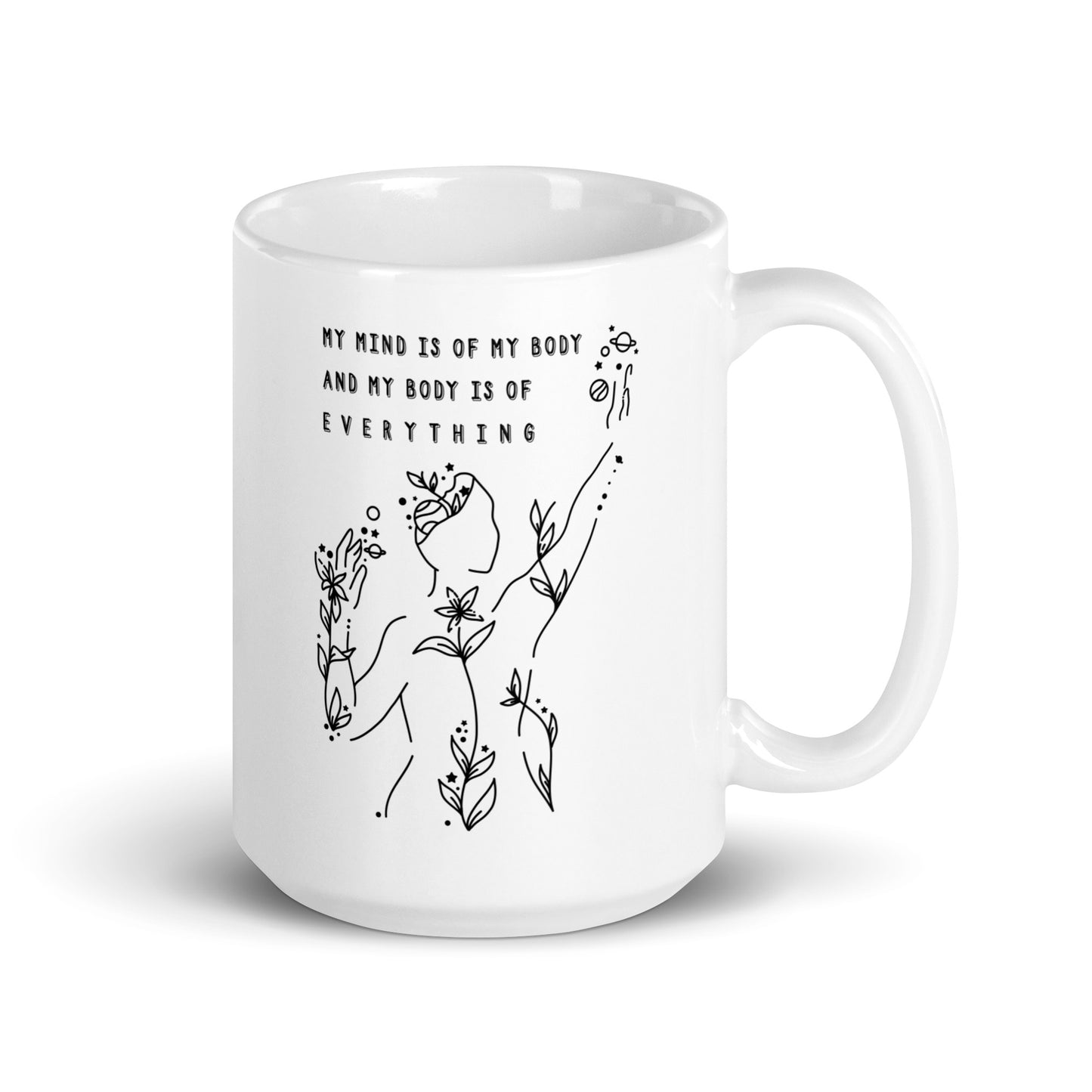 A  white 15 ounce coffee mug featuring an abstract illustration of a figure whose body is spreading out into plants and planets and stars. Text above the figure reads "My mind is of my body and my body is of everything."
